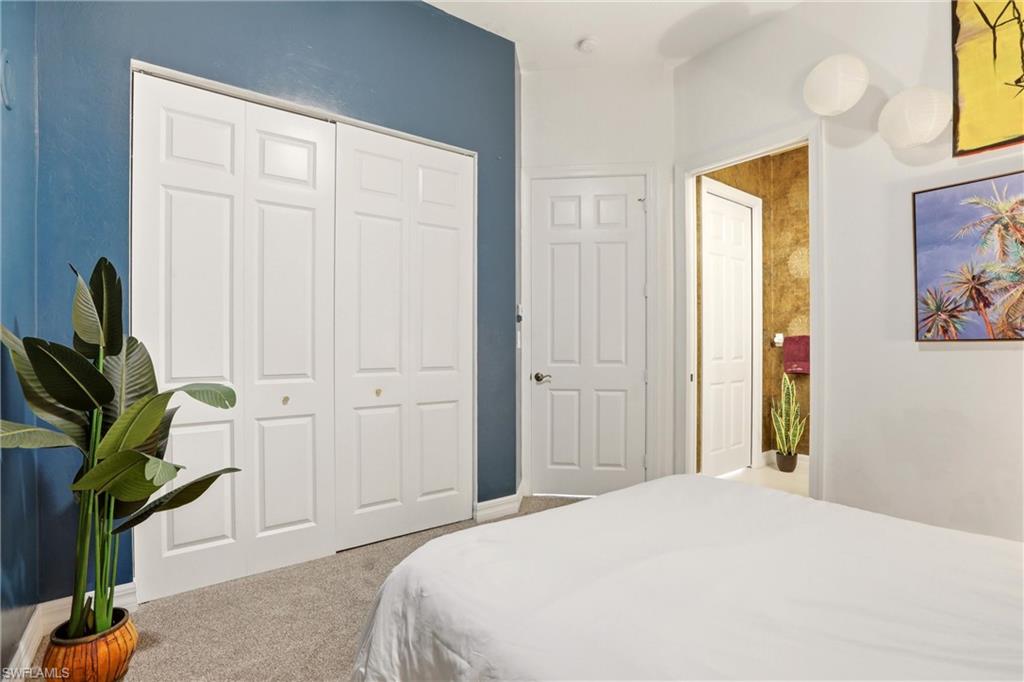 Bedroom with carpet and a closet