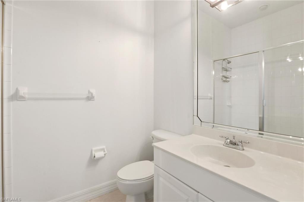 Bathroom featuring vanity and a stall shower