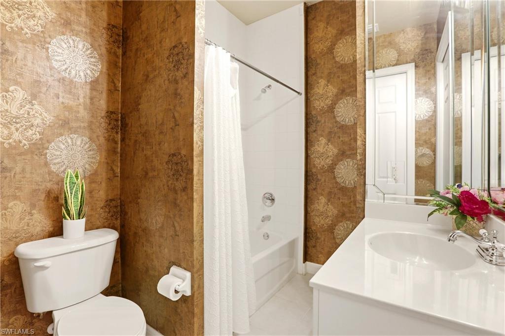 Bathroom featuring vanity and shower / bath combo with shower curtain