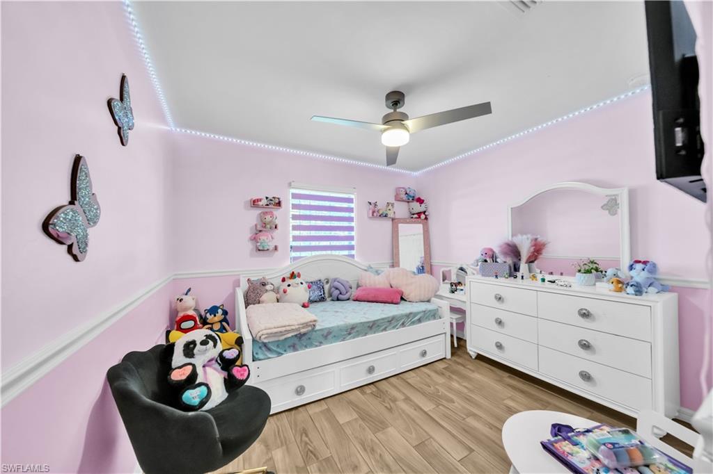 Bedroom with light wood-style floors and ceiling fan
