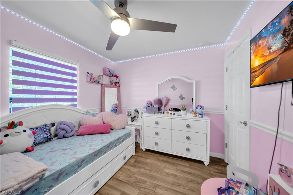 Bedroom with light wood finished floors and ceiling fan
