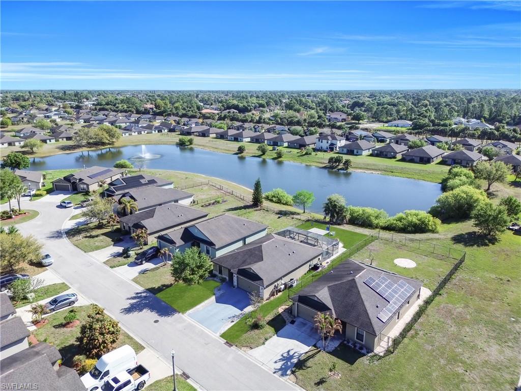 Aerial view of residential area featuring a nearby body of water