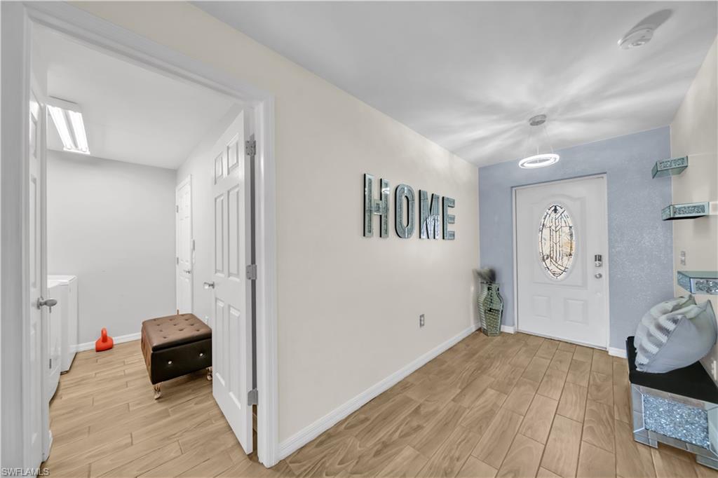 Entryway featuring light wood-type flooring and baseboards