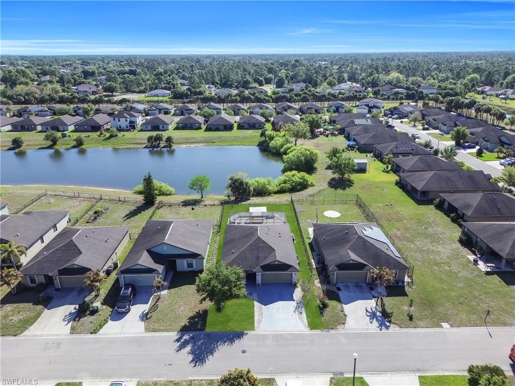 Aerial perspective of suburban area featuring a nearby body of water