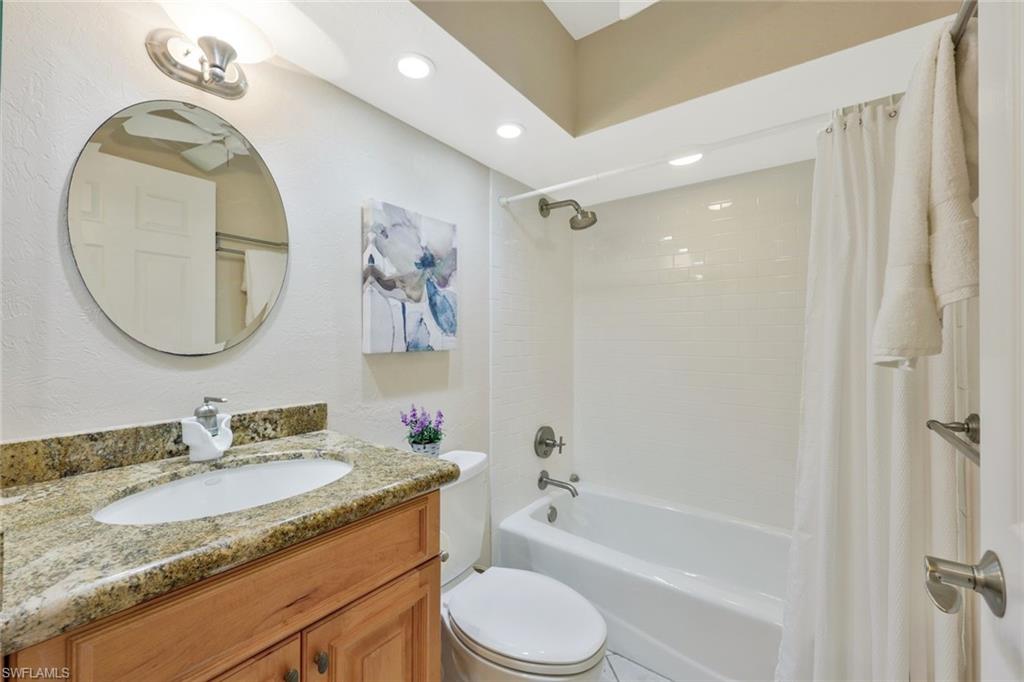Full bathroom featuring shower / tub combo, toilet, and vanity