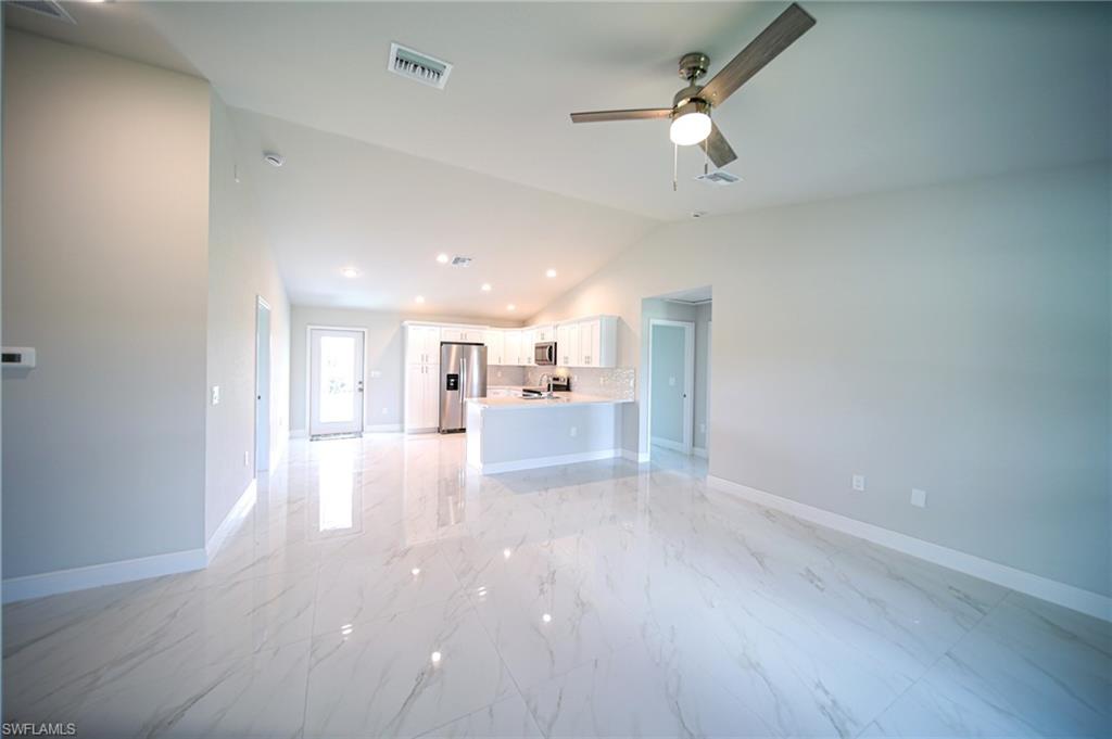 Oversized Titled Living Room With Lighted Ceiling Fan And Vaulted Ceiling!