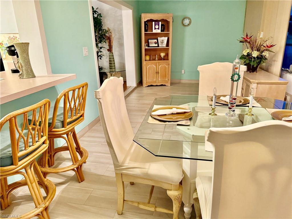 Dining area featuring baseboards and light wood-style flooring