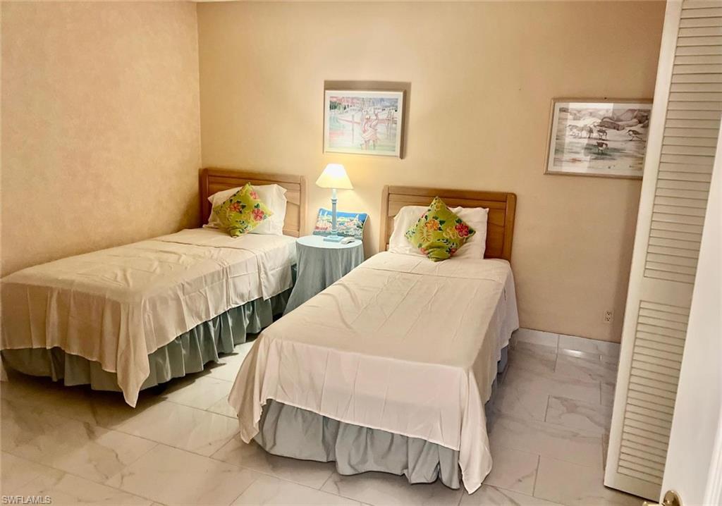 Bedroom with marble-like tile flooring