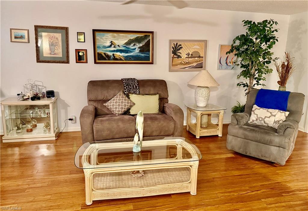 Living room featuring wood finished floors and ceiling fan