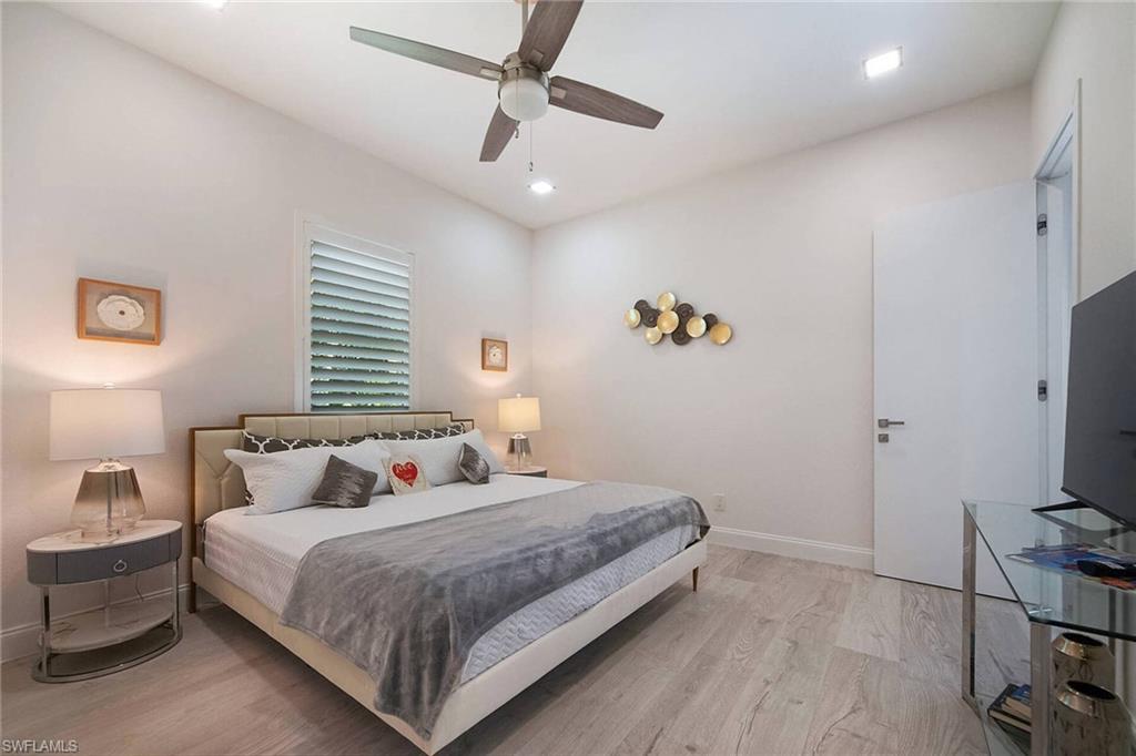 Bedroom featuring light wood finished floors, a ceiling fan, and recessed lighting