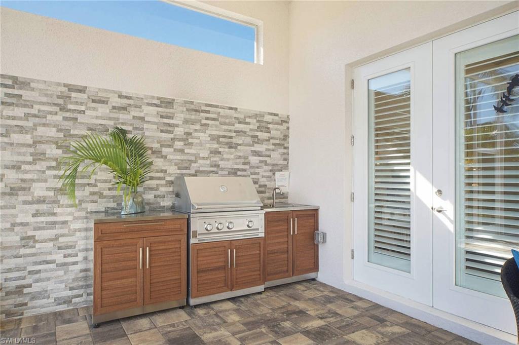 View of patio / terrace featuring french doors and exterior kitchen