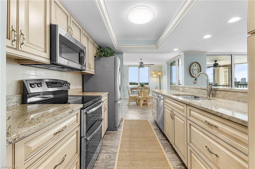 The kitchen features raised panel wood cabinetry, granite countertops and stainless steel appliances.