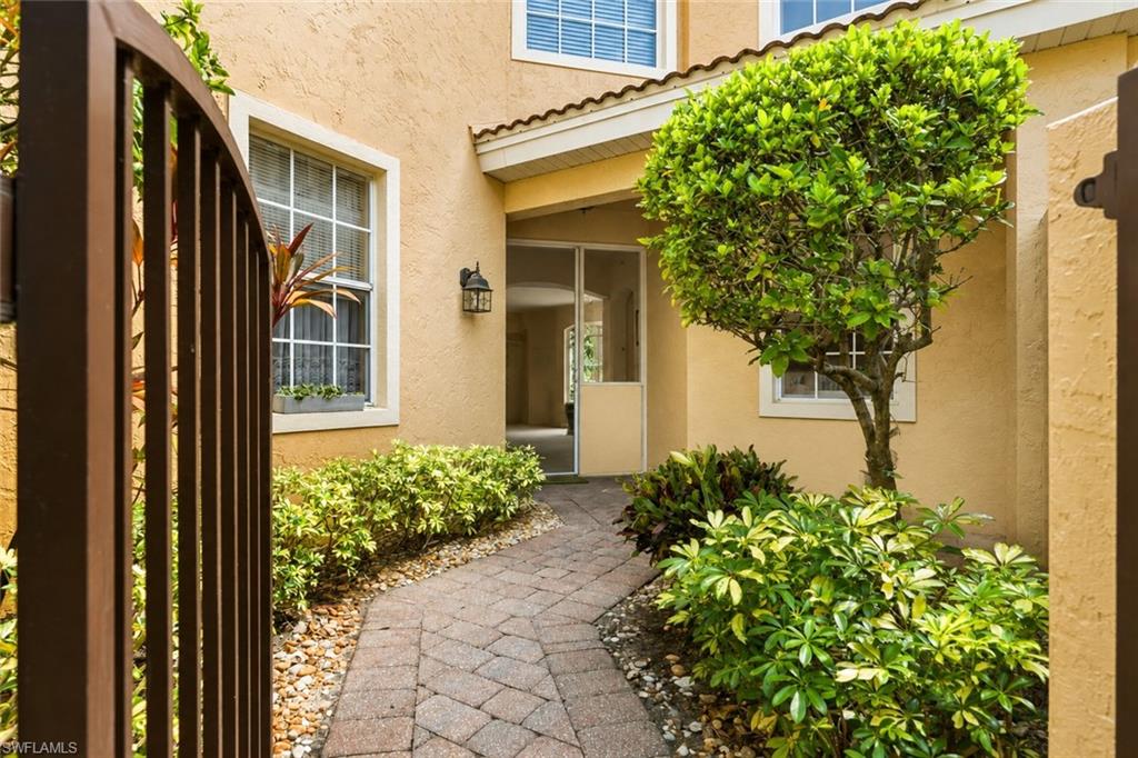 Private courtyard entrance with seating - one of few units with this feature. Retracting door screen allows for cross breeze  throughout the home.