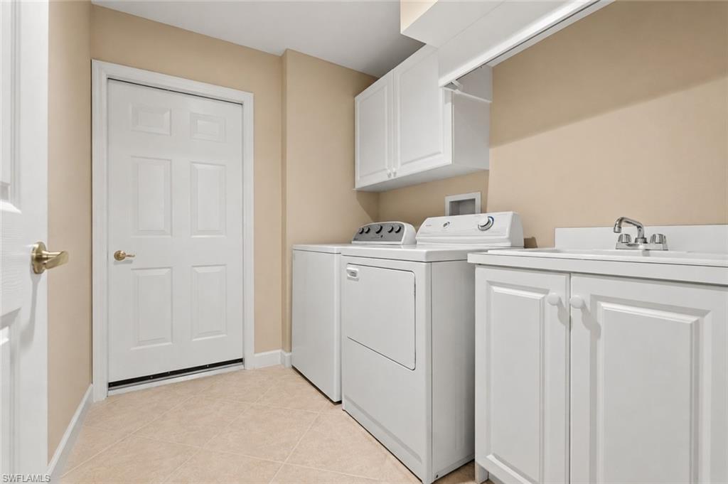 Laundry room with lots of cabinet storage, and laundry sink.