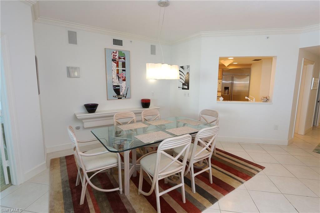 Dining space with visible vents, baseboards, light tile patterned flooring, and crown molding