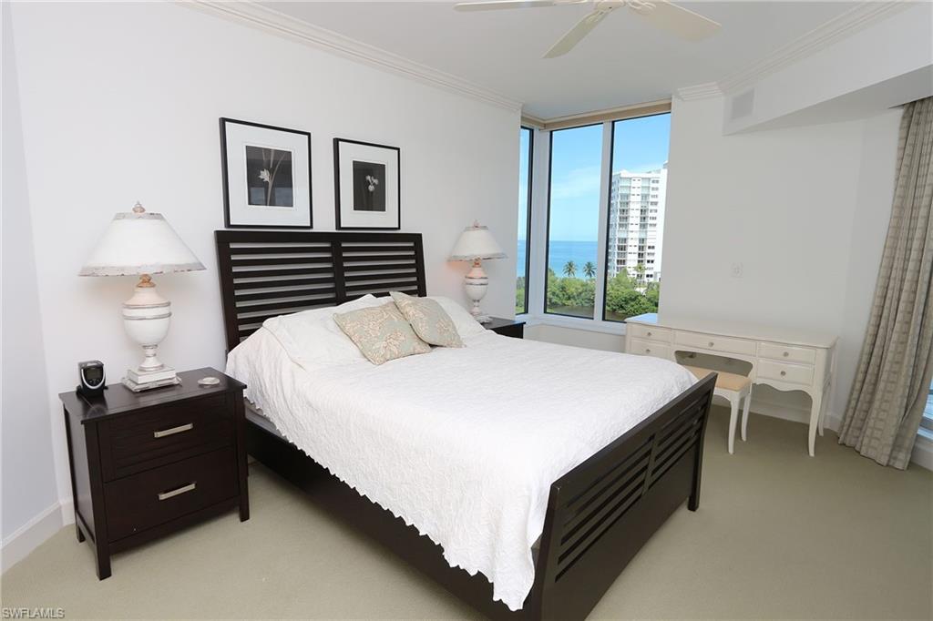 Bedroom with light carpet, visible vents, baseboards, a ceiling fan, and ornamental molding
