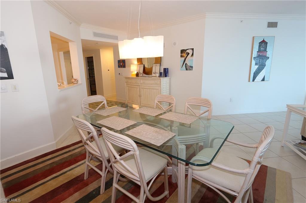 Dining room featuring crown molding, visible vents, and light tile patterned floors