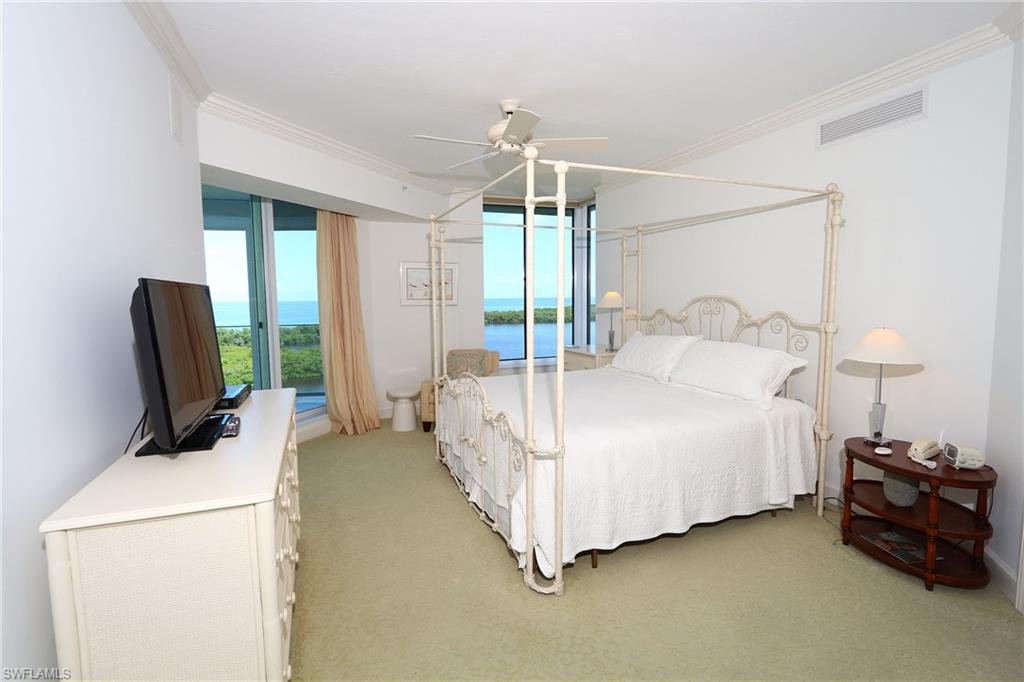 Bedroom with light carpet, a ceiling fan, visible vents, and crown molding