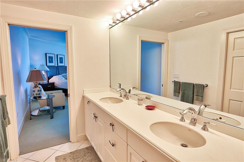 Ensuite bathroom with tile patterned floors, ensuite bathroom, and a sink