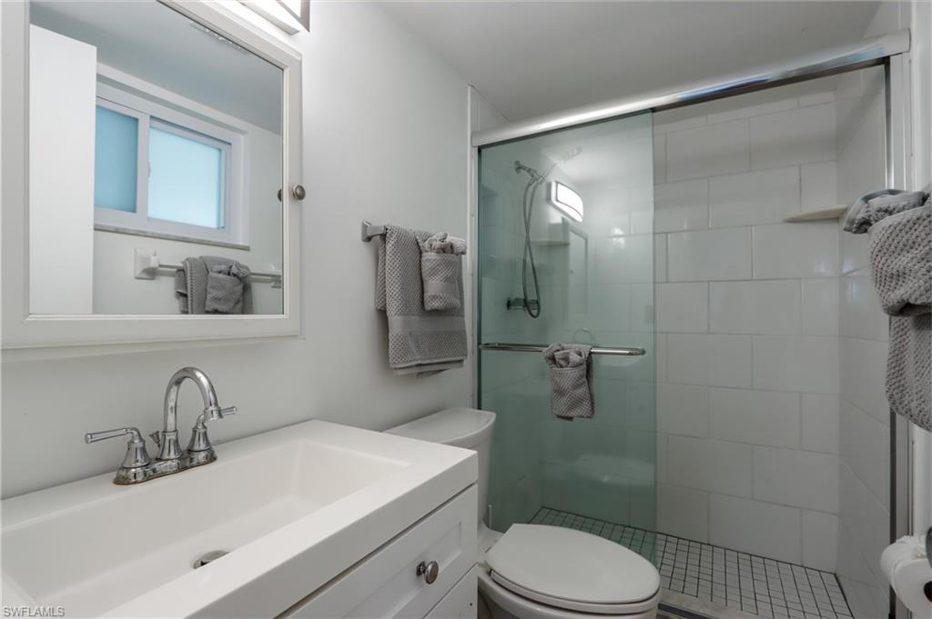 Full bath with a stall shower and vanity