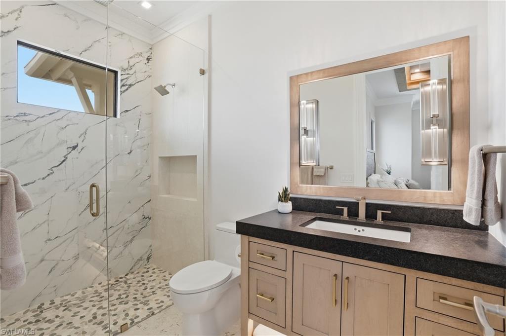Full bathroom with vanity, a marble finish shower, crown molding, and ensuite bath - Virtually Edited Image