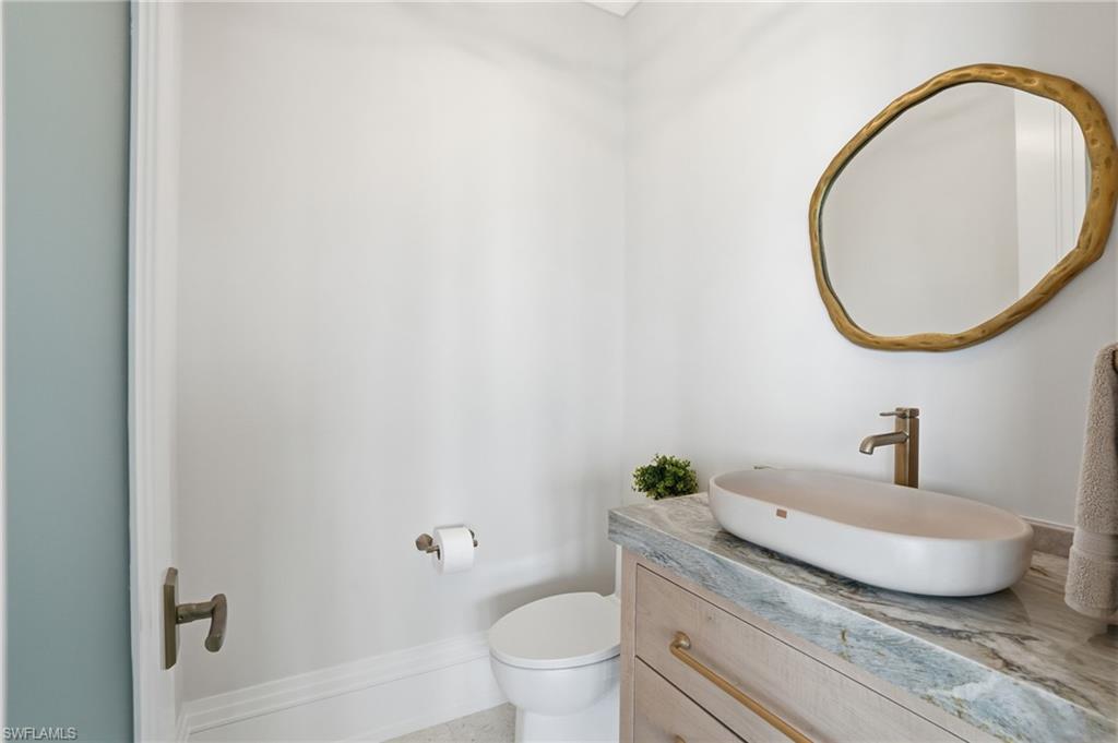 Half bathroom with toilet and vanity - Virtually Edited Image