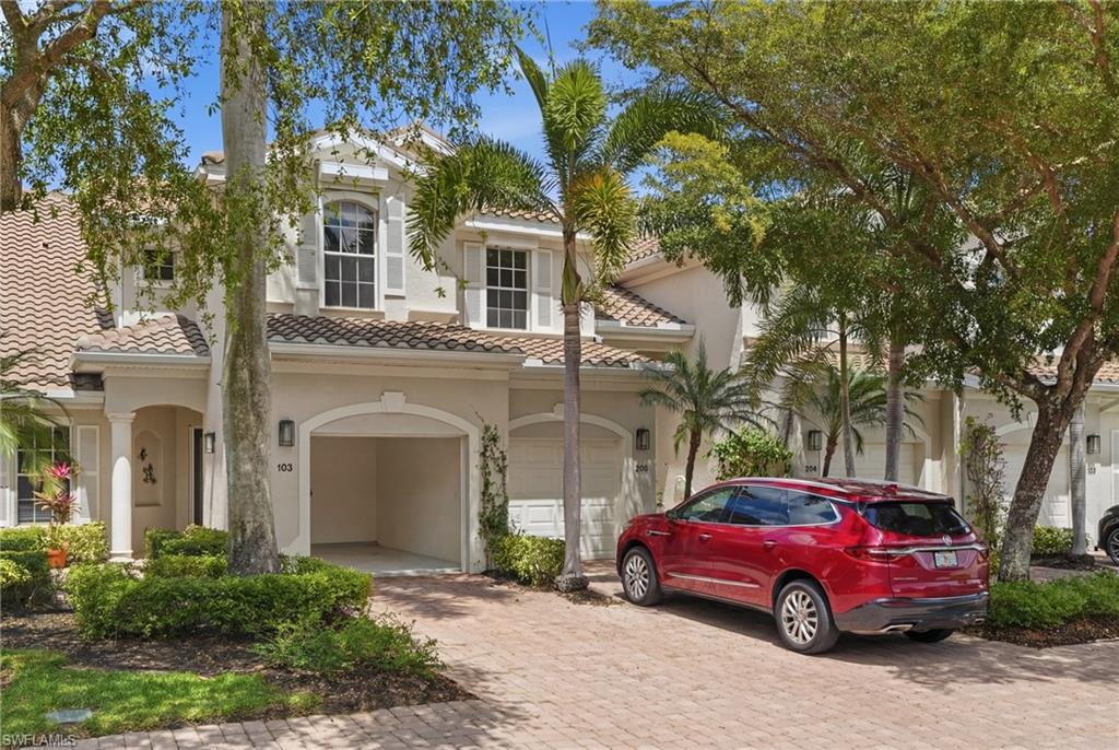 Mediterranean / spanish-style home featuring decorative driveway, stucco siding, a tile roof, and an attached garage