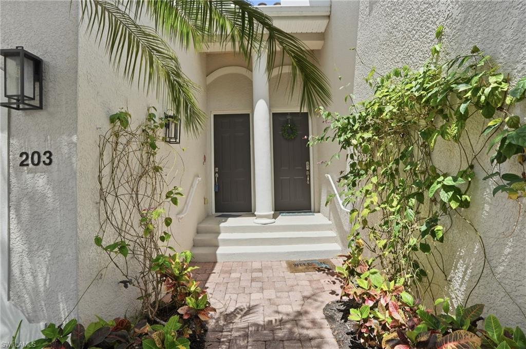 Entrance to property featuring stucco siding