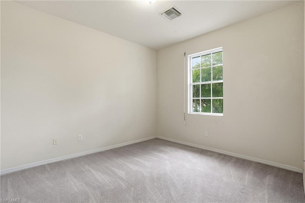 Empty room featuring baseboards and light colored carpet