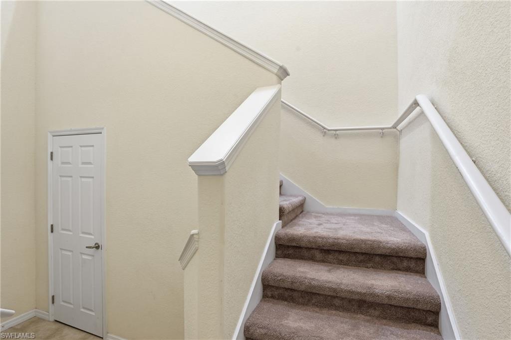 Stairway with a textured wall and carpet