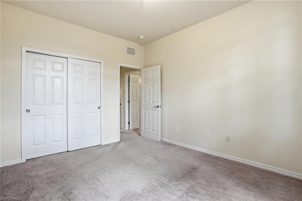 Unfurnished bedroom featuring carpet flooring and a closet