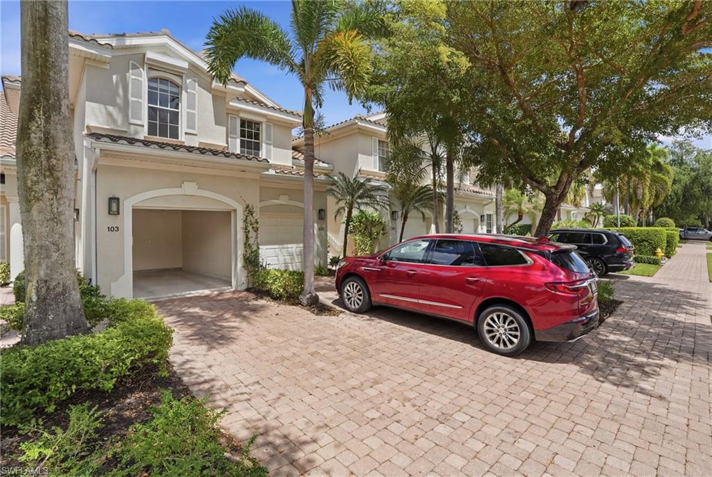 Mediterranean / spanish-style home with stucco siding, decorative driveway, a tile roof, and a garage