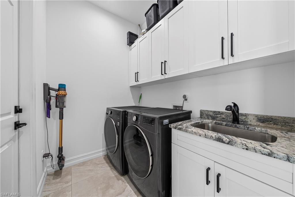 Laundry area with cabinet space and washer and clothes dryer
