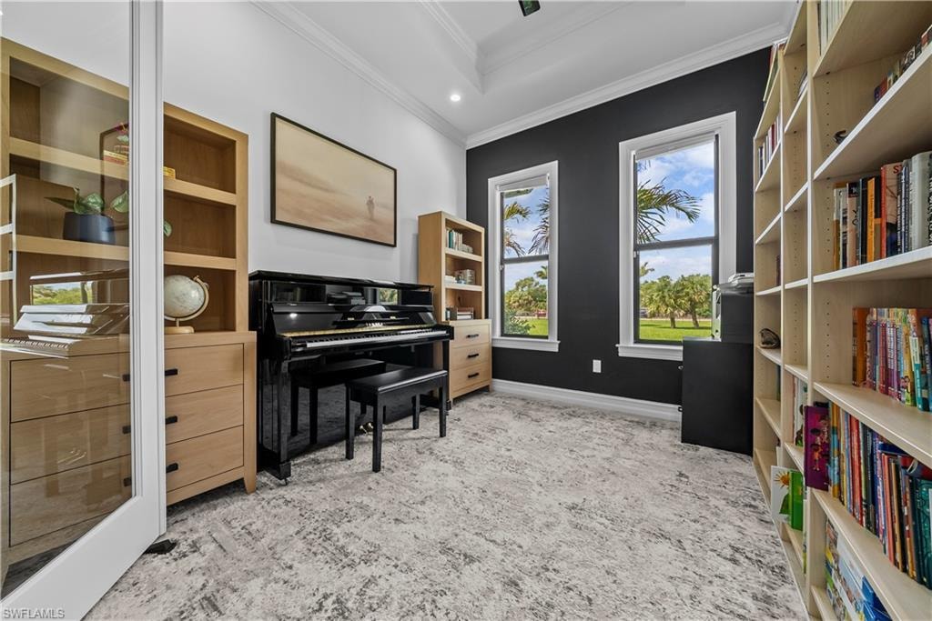 Living area featuring ornamental molding, recessed lighting, and an office area