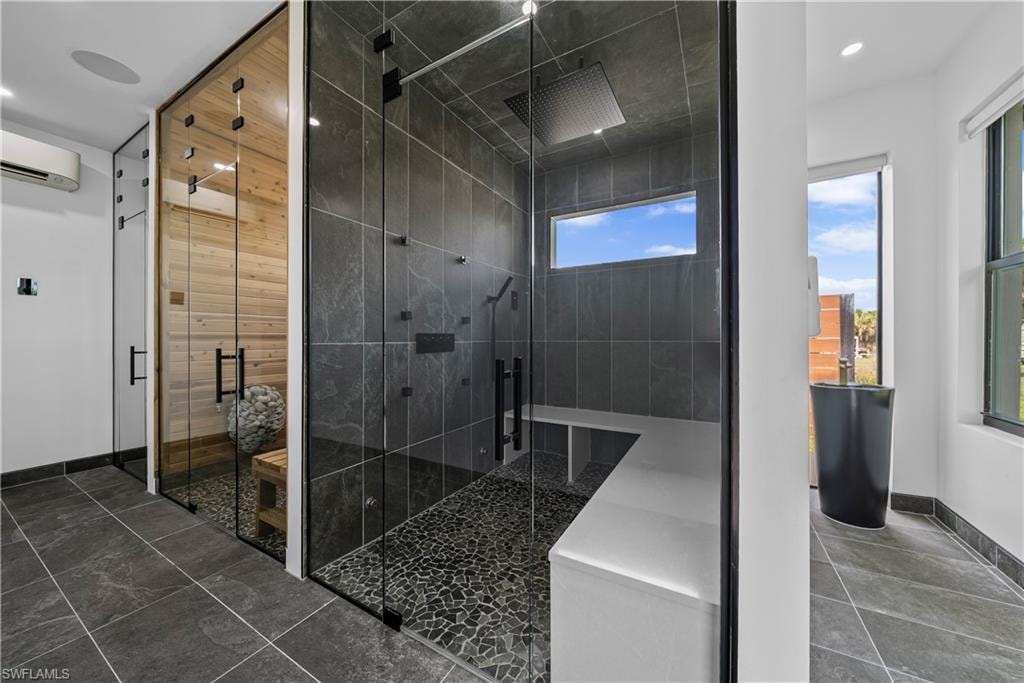Bathroom with a stall shower, recessed lighting, and a sauna