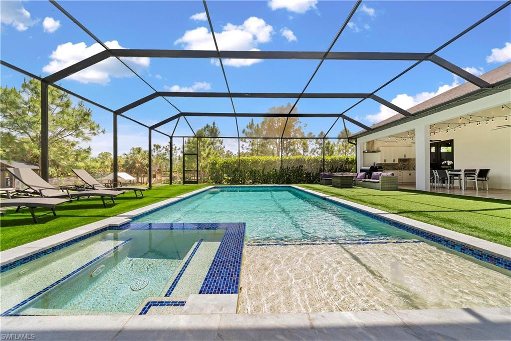 Integrated pool / hot tub featuring a lawn, a sunroom, and a patio