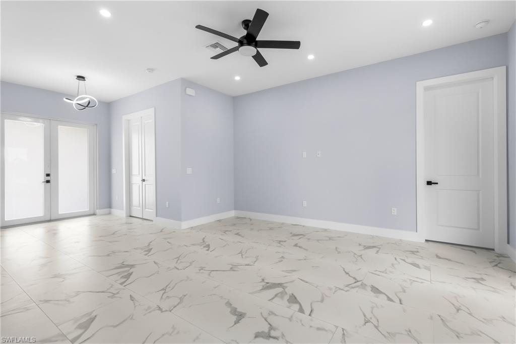 Unfurnished room featuring french doors, light marble finish floors, recessed lighting, and ceiling fan