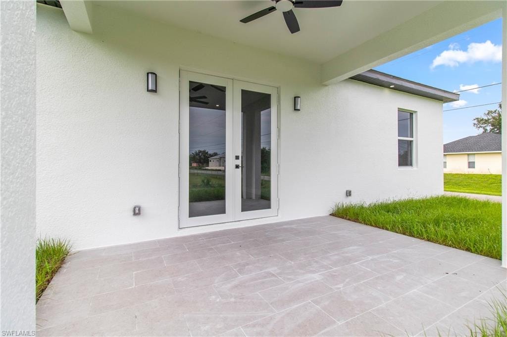 View of patio with french doors and a ceiling fan