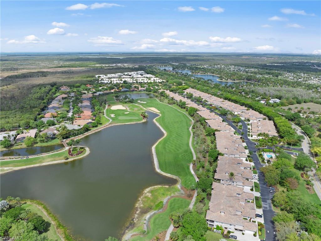 View of property location with nearby suburban area, a large body of water, and a golf club