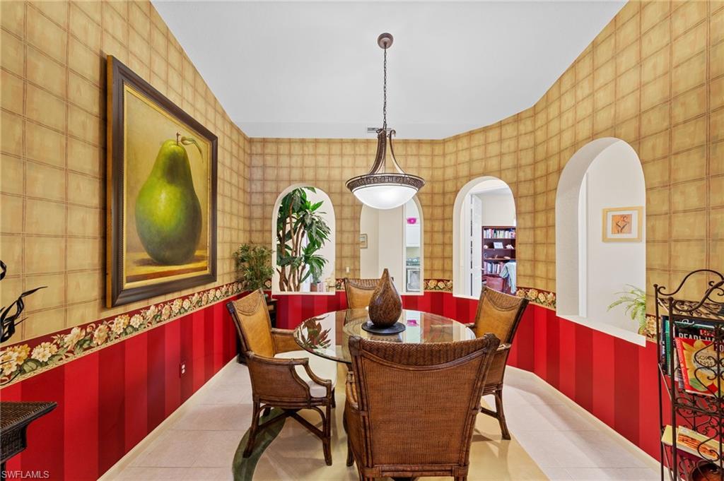 Dining area featuring wallpapered walls and arched walkways
