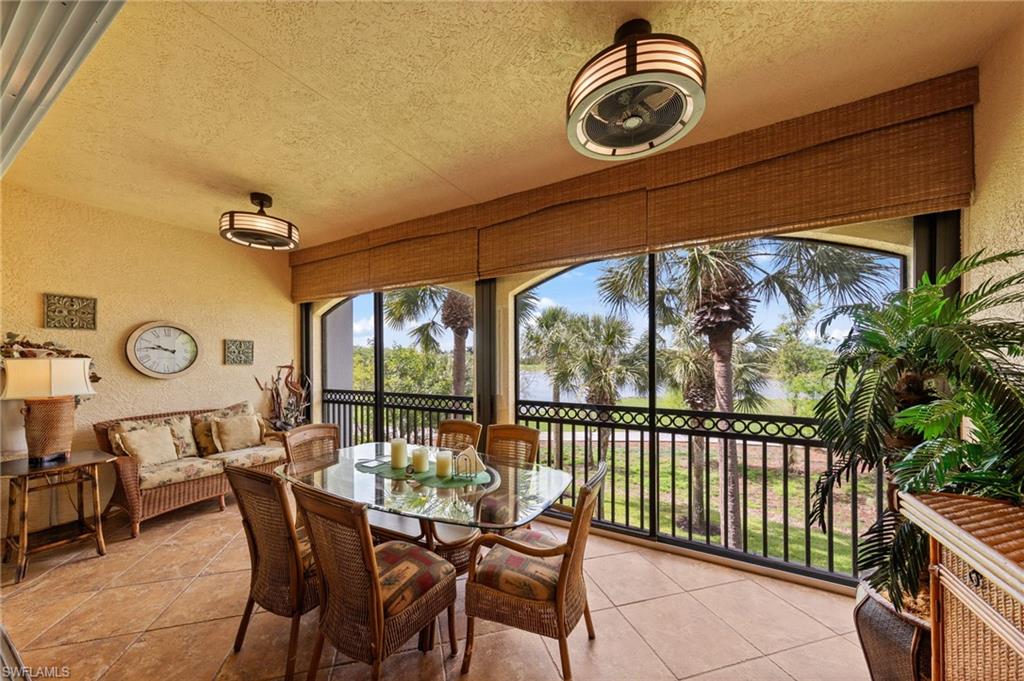 Sunroom with a textured wall, a textured ceiling, and tile patterned flooring