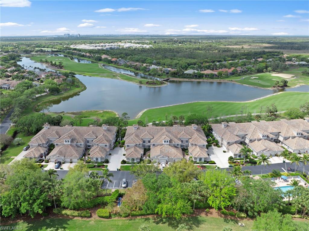 Aerial perspective of suburban area with a local golf course and a large body of water