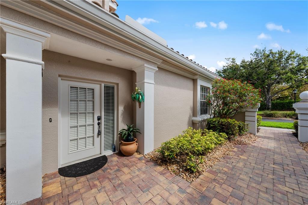 View of exterior entry with stucco siding