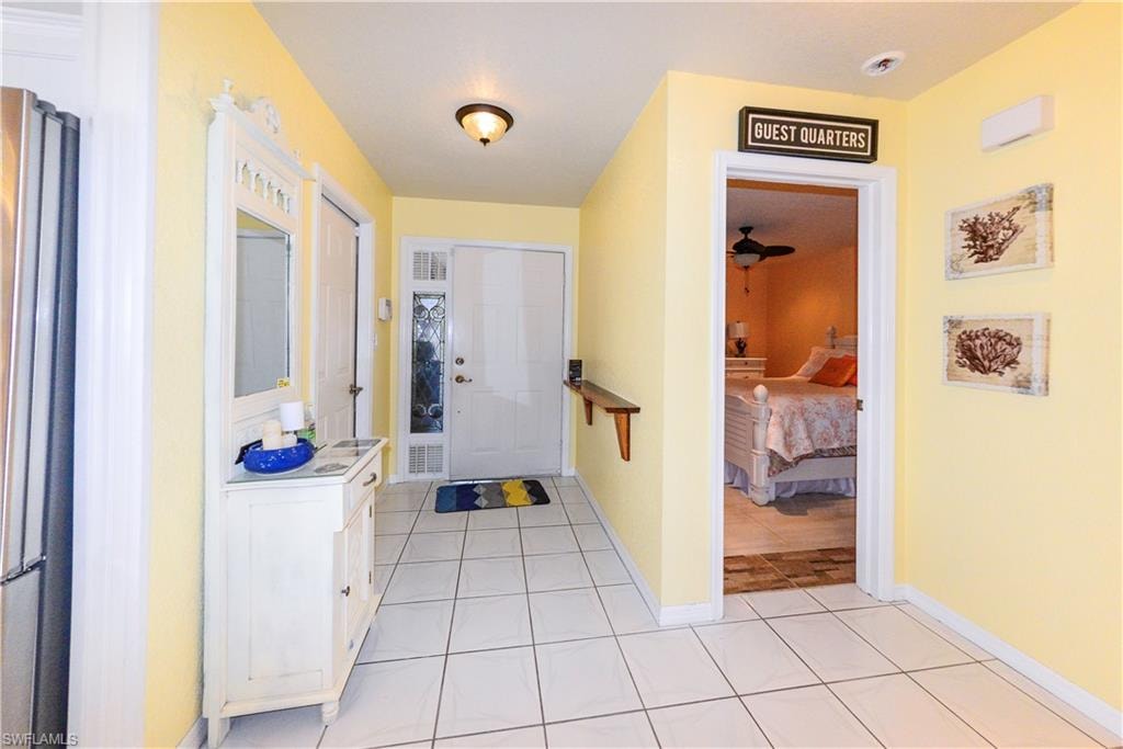 White tile flooring throughout the hallway
