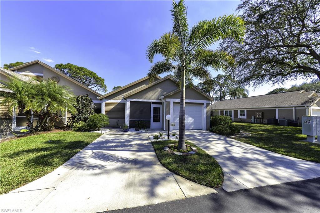 Concrete driveway leading to a single-car garage and screened entry
