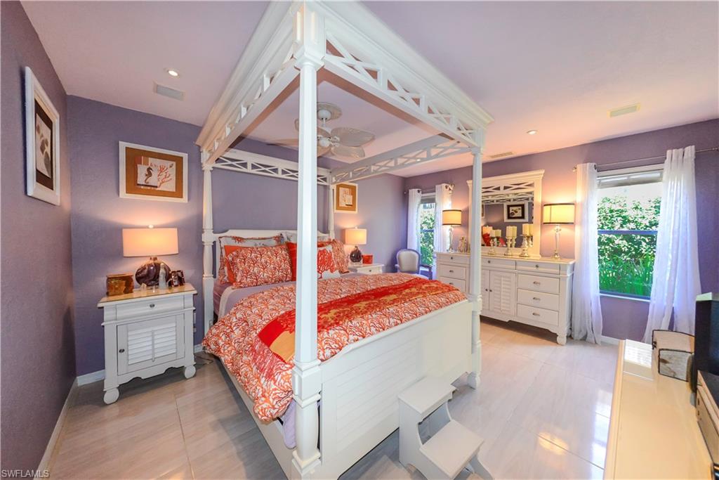 Recessed ceiling lighting, a ceiling fan, and light-tone tile flooring