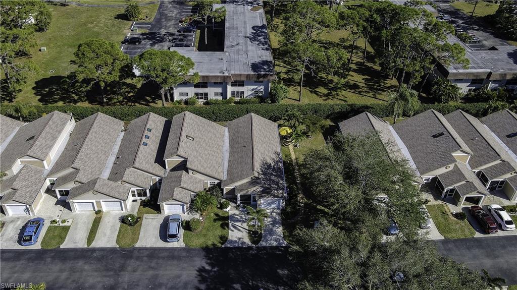 Row of residential properties featuring attached garages, individual driveways, and sloped roofing