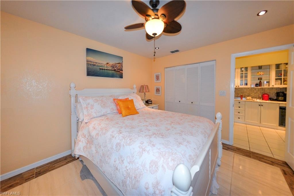 Living space with a ceiling fan, recessed lighting, and a closet with louvered bifold doors