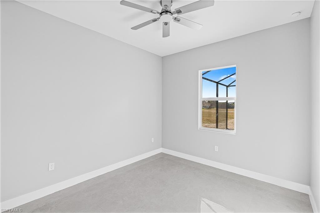 Spare room featuring concrete flooring and ceiling fan
