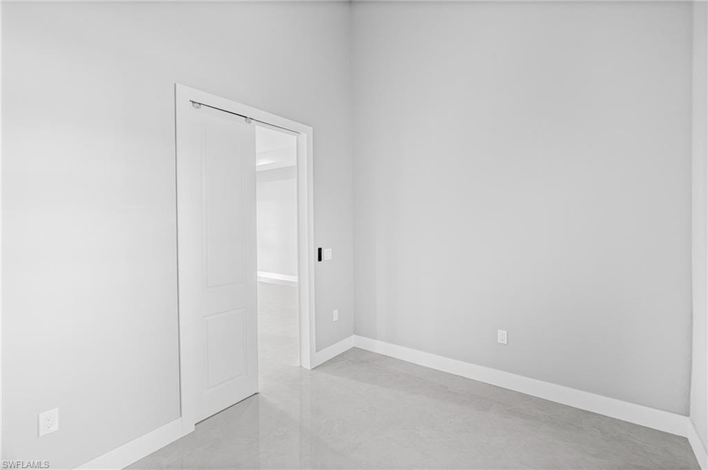 Spare room with baseboards and concrete flooring